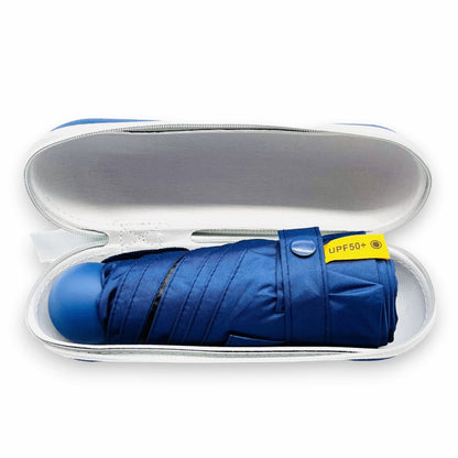 Pakabel compact navy blue umbrella with UPF50+ protection, folded in its protective case.